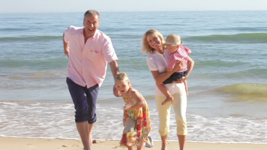Grandparents with grandchildren running towards camera from shoreline. Shot on Canon 5d Mk2 with a frame rate of 30fps