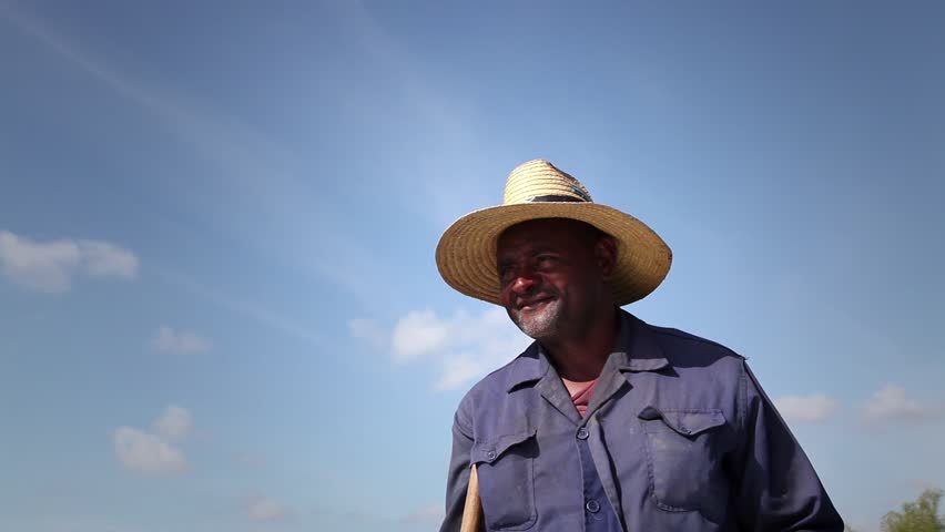 GUINES, CUBA - CIRCA APRIL 2013: Beginning of the growing season, portrait of black peasant with hat in farm, circa April 2013 in Guines, Cuba