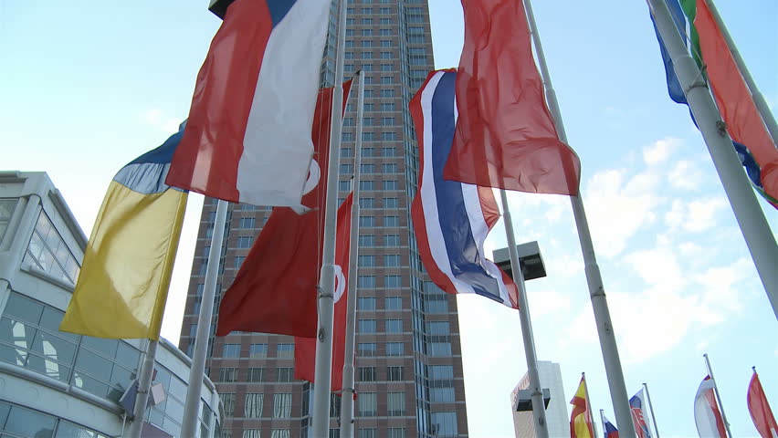 Flags at Messe in Frankfurt with Messeturm skyscraper in the back