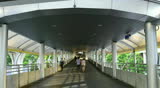 City sky walk crowded with people commuters walking
