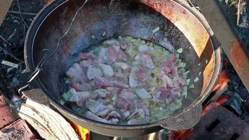 Cooking pilaf. The meat is stewed with onions