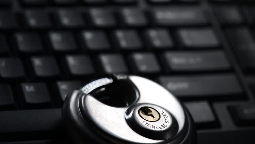 Internet Security Concept for Identity Theft. A Flashlight passing over a Keyboard in the Dark.