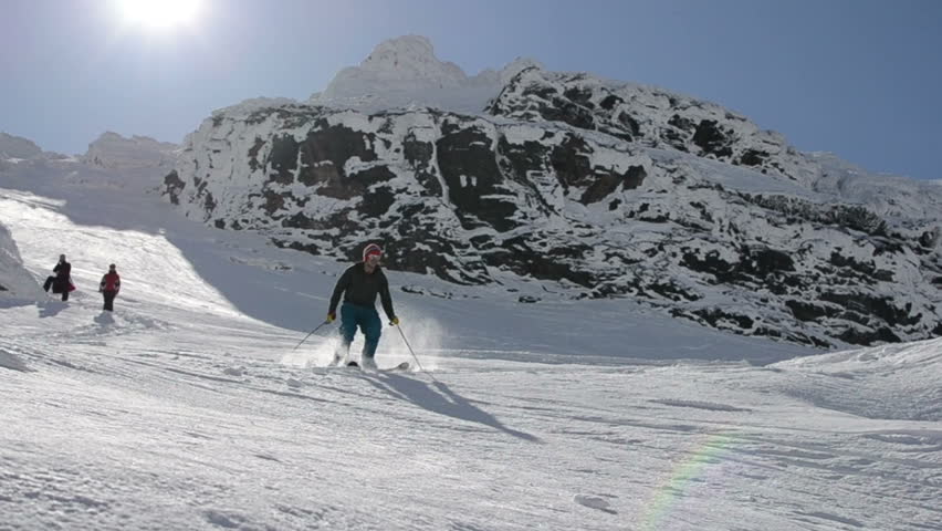 Free ride skier jumping off cliffs in powder snow 
