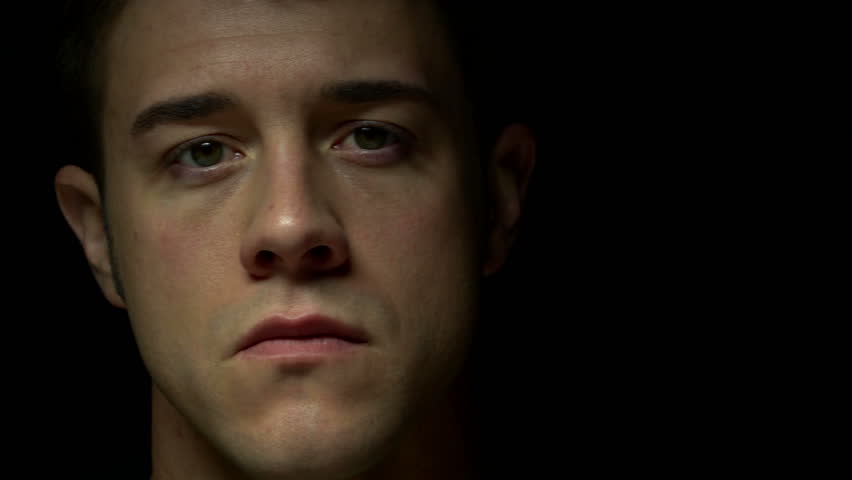 Dolly shot of man in color. Experimental lighting. 