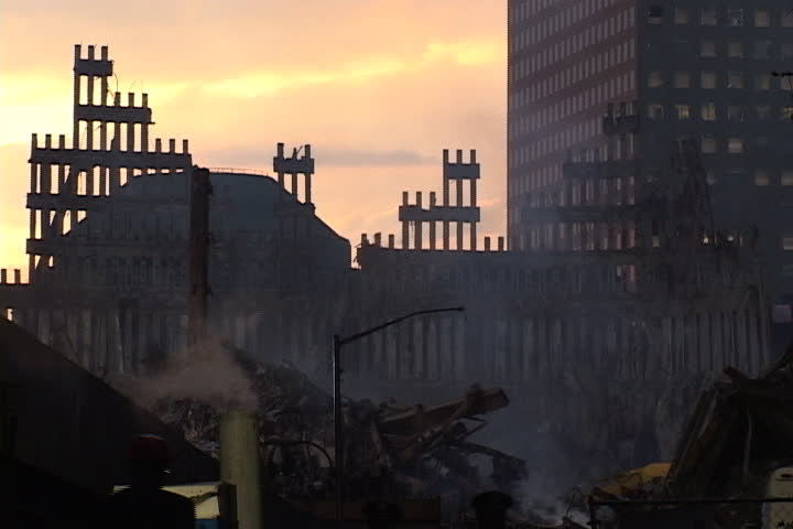 NEW YORK CITY - SEPTEMBER 28, 2001: Silhouettes of World Trade Center remains against sunset. Smoke rises from pit of rubble.