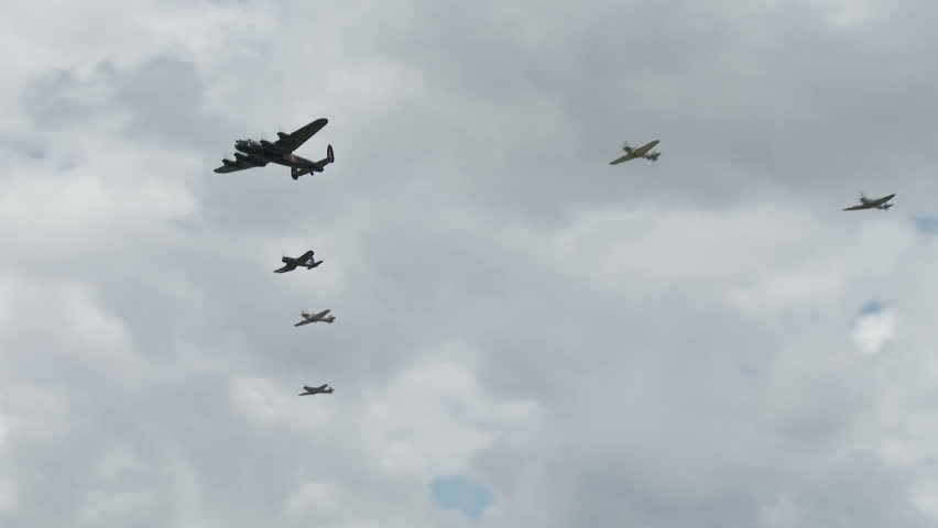 Avro Lancaster bomber flying in formation with RAF Spitfires, a Hurricane and a US Navy Corsair from World War II.