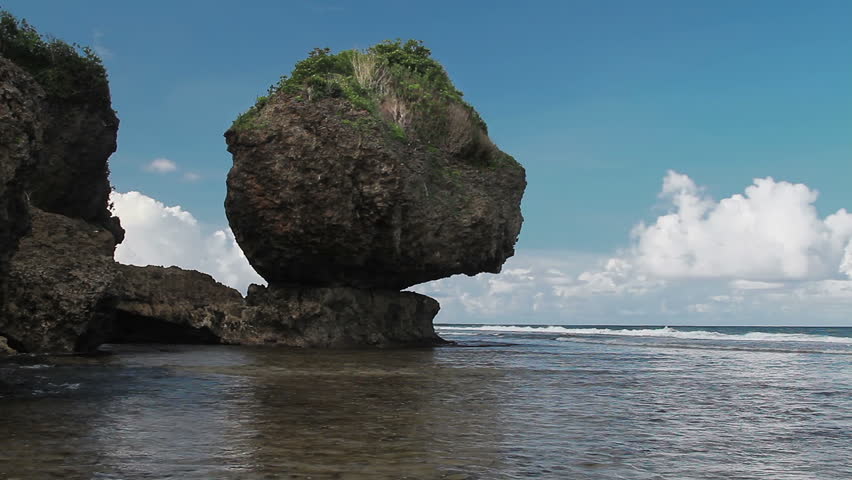 Picturesque rock on the Pacific Ocean bay, Siargao, Philippines.