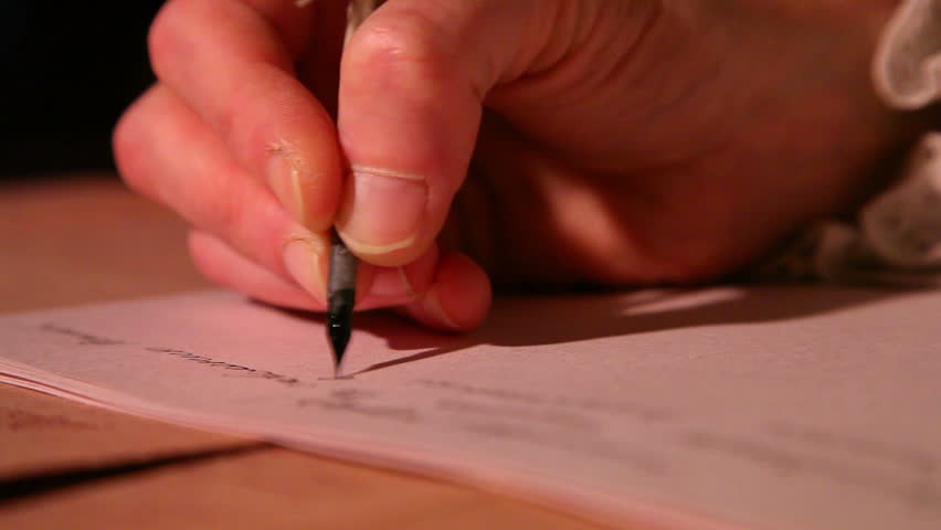 man writes a letter with quill pen