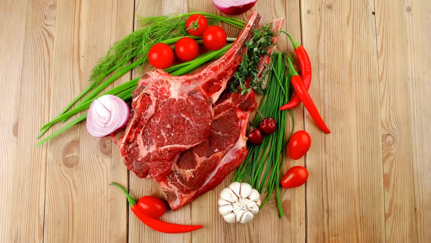 fresh meat : raw beef spare ribs with thyme red chili pepper garlic dill and cherry tomato on wooden board 1920x1080 intro motion slow hidef hd