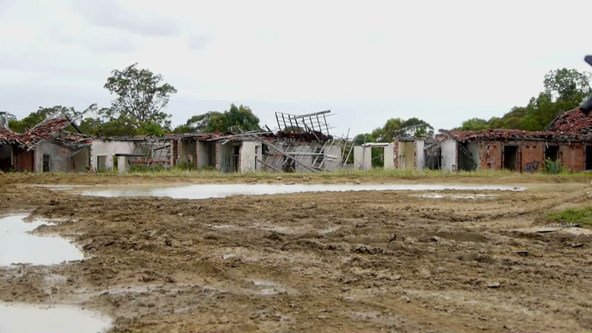Ungraded shot of Army soldier walking through ruins