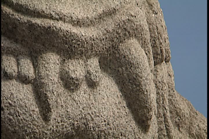 SEOUL - CIRCA FEBRUARY 2003: Scenic shots of Seoul; CU teeth of carved stone dragon (or it could be a lion) statue. Wider shot stone dragon on pedestal next to palace.