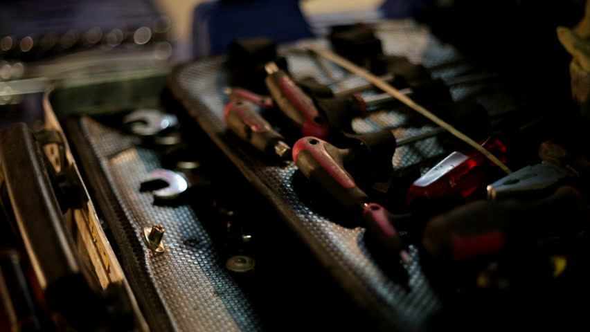 Tools for working with mechanical stuff. Repairing cars. Focus from on to another.