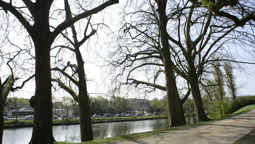 Panoramic footage of water tower, park and cyclists in Bruges,Belgium