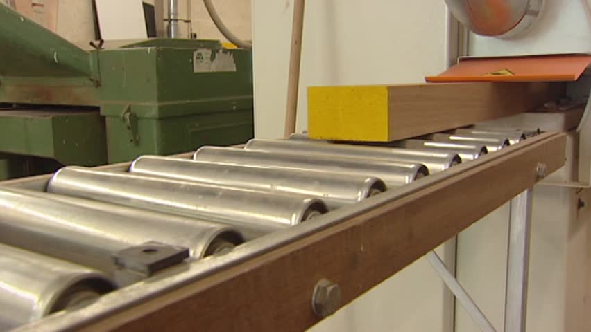 Shelf rolls out of sawing machine on rolling road.