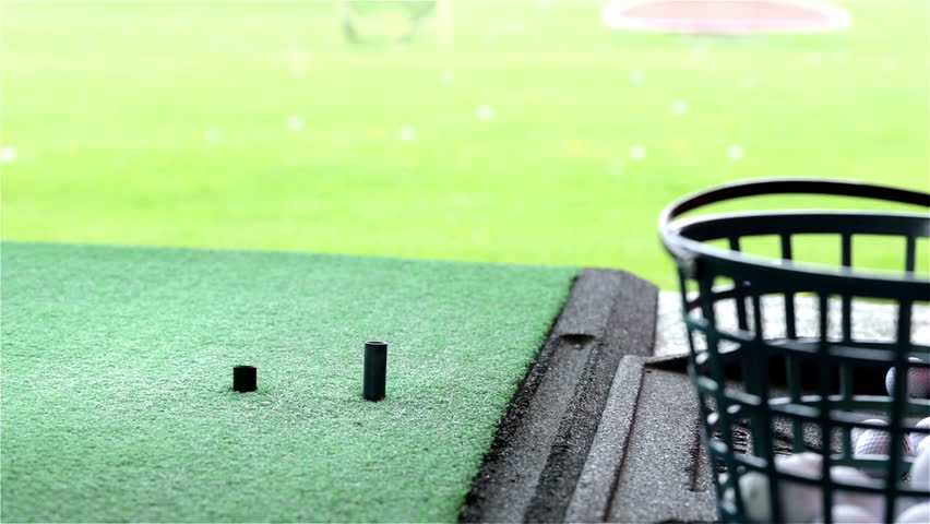 Golfer practicing on the golf driving range.