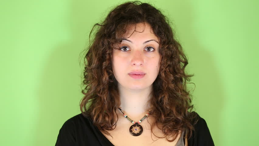 Young Woman Gesturing on Green Background