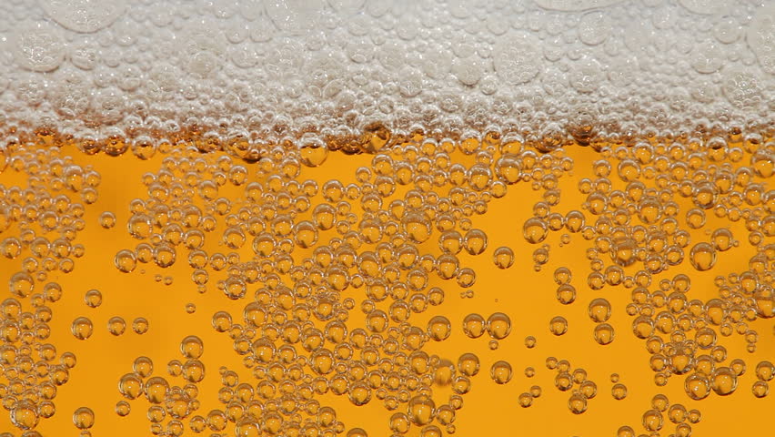 Macro of beer pouring to glass.