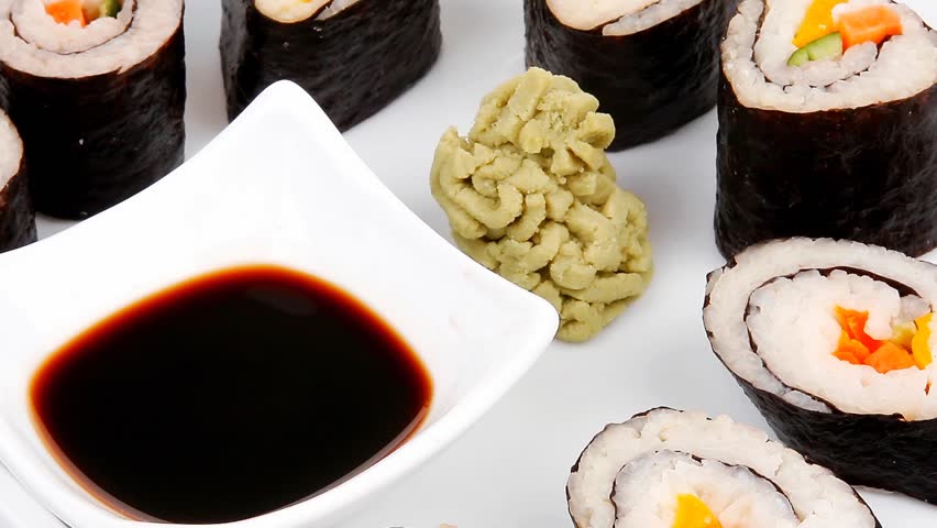 Maki Sushi : Maki Rolls and California rolls made of fresh raw Salmon(sake) Tuna(maguro) and Eel(unagi) . dish with sticks 1920x1080 intro motion slow hidef hd
