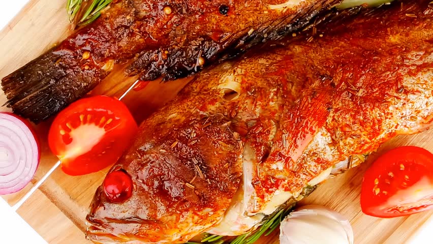 main portion of two grilled fish served on wooden plate 1920x1080 intro motion slow hidef hd
