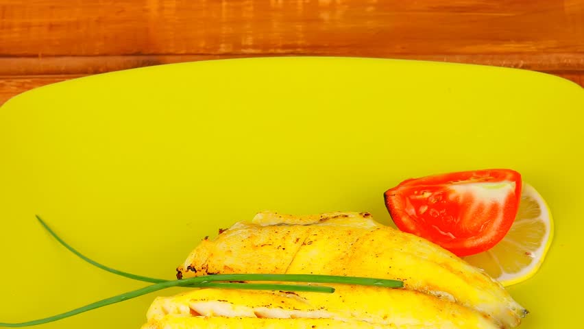 grilled fish fillet served over wood with tomatoes olives and bread 1920x1080 intro motion slow hidef hd
