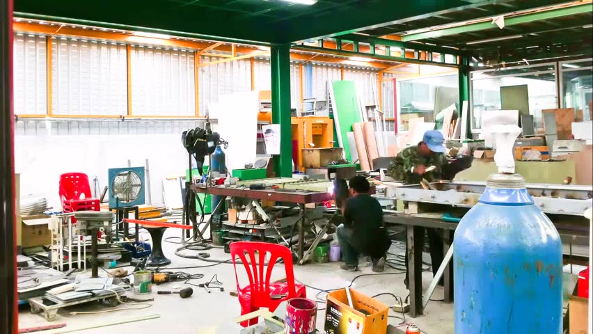 Bangkok, Thailand - May 2013 : Time lapse of workers welding and bright sparks in furniture factory