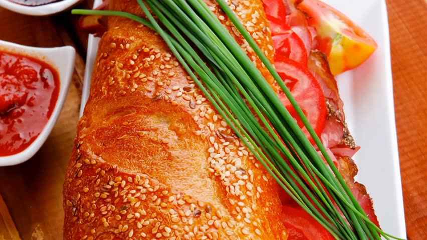sandwich : fresh french white baguette with chicken smoked sausage on ceramic plate over wooden table 1920x1080 intro motion slow hidef hd