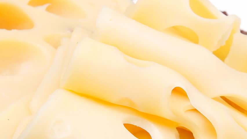 gold swiss cheese sliced on wooden platter with olives and tomato 1920x1080 intro motion slow hidef hd