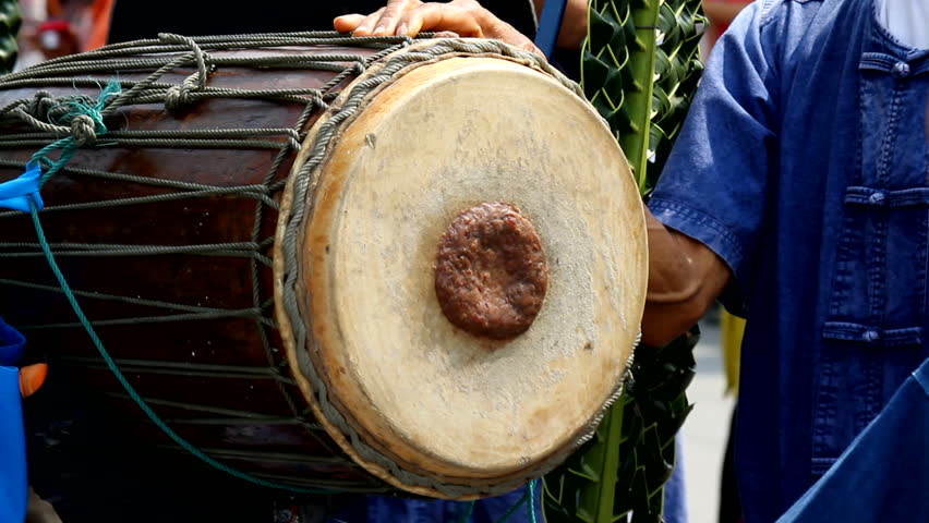 A man hit the ancient drum with Thai northern Native bands.