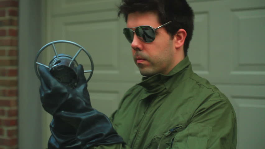 Pilot or flight mechanic looking at a strange part.