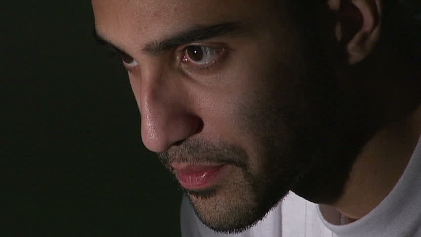 Inmate in jail cell thinking, as the camera zooms out. BONUS: an extra version where he is holding his head.
