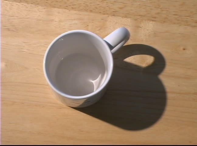 Pouring a cup of hot coffee.