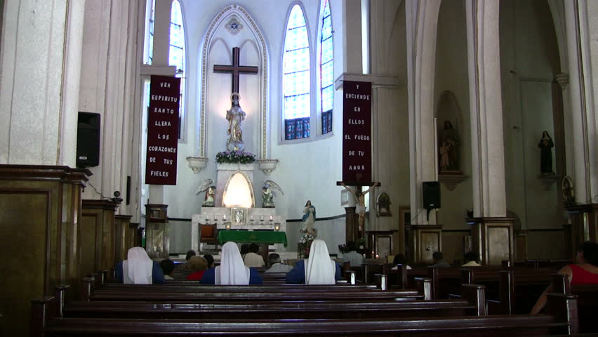 Video old church Matamoros Mexico. Three nuns praying. Border Brownsville TX. Columns and altar. Statues Jesus Christ. Catholic Christian cathedral. Wood pews. Vaulted. Don Despain of Rekindle Photo