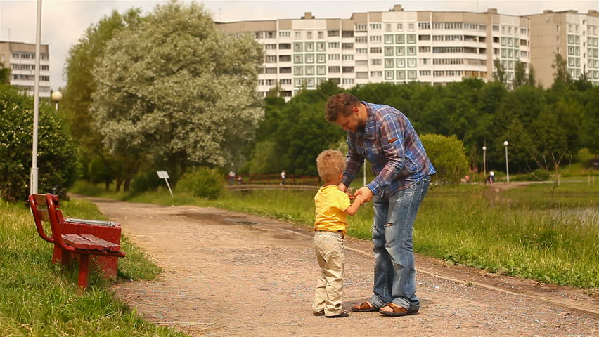 Father turns child's hands.