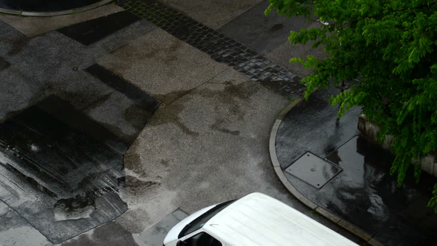 Rain drops falling on the road 