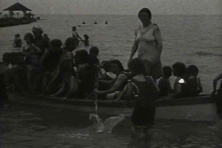 1910s, 1920s - Scenes of women and children playing at the beach.