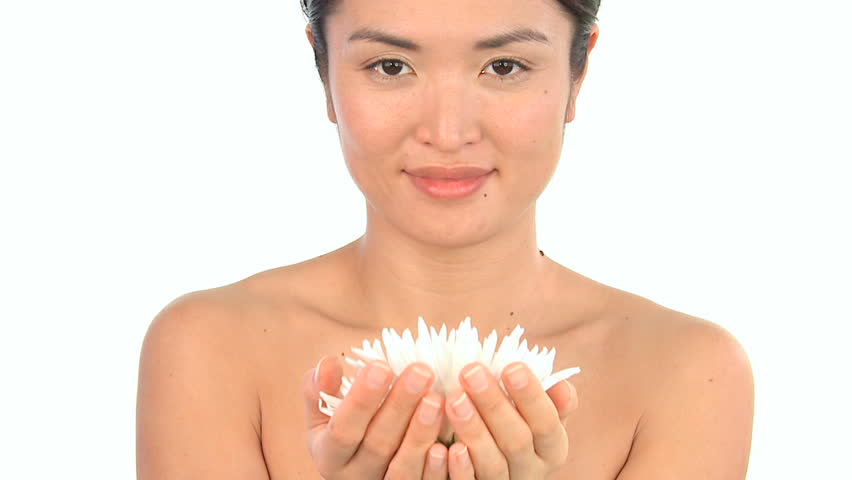 Young oriental japanese girl enjoying the therapeutic aroma of flowers
