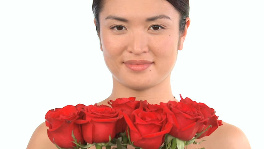 Young Japanese girl enjoying the therapeutic aroma of flowers