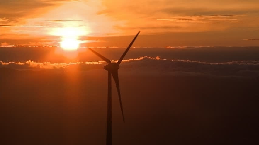 Wind turbine in the mountains at sunset