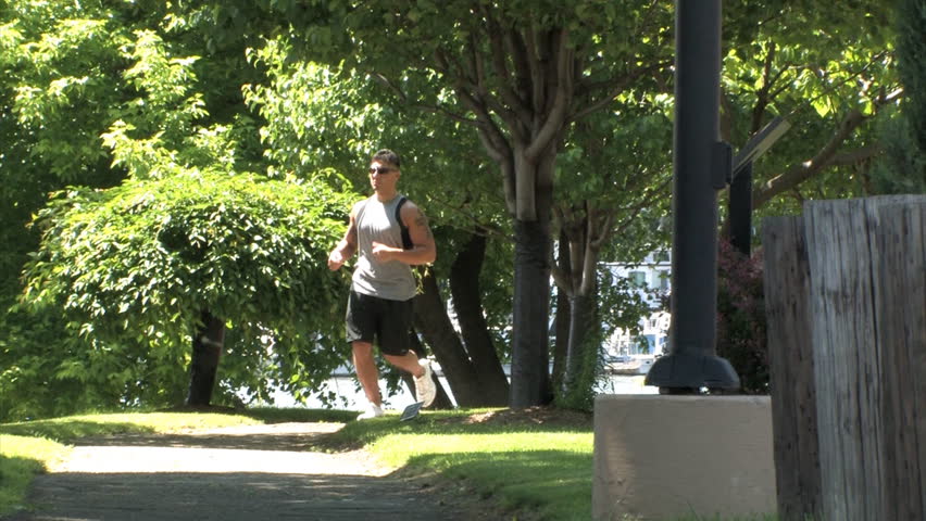 A man jogs in the park.