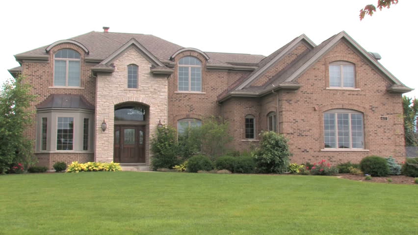 Slow zoom out on a large brick house 