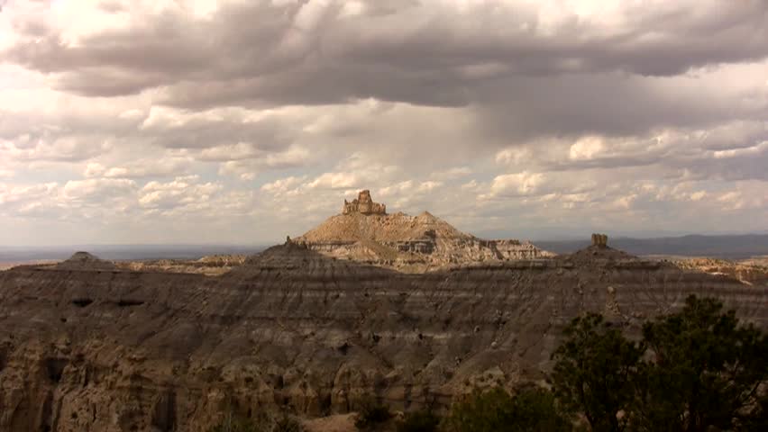 HD zoom in from a wide view of the badlands of northern New Mexico to a tight view of Angels Peak