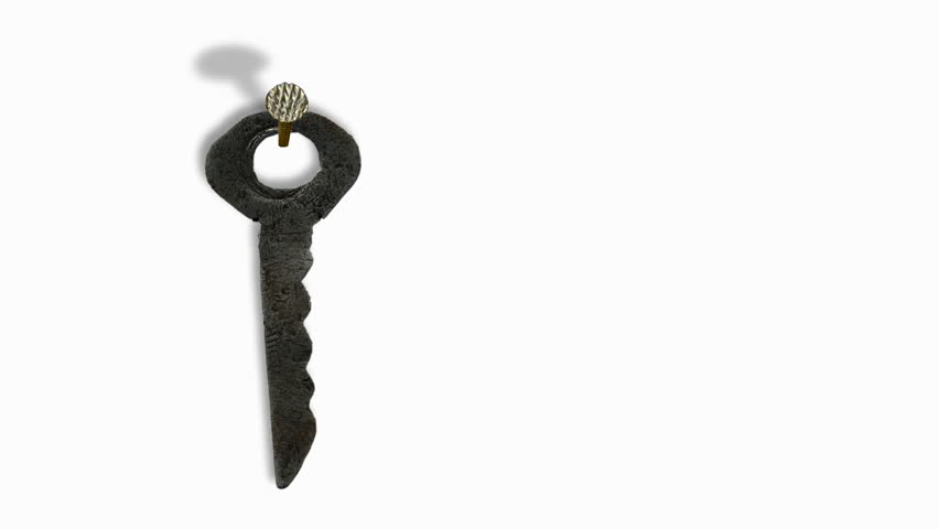 Key is hanging on nails and is moving from the draft.White background. 
