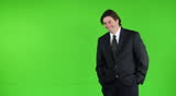 Happy dynamic business man standing off-center - green screen
