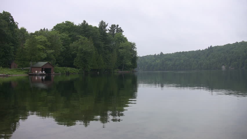 Cottages on the lake. Cottages and reflections on a freshwater lake. Quebec, Canada. 