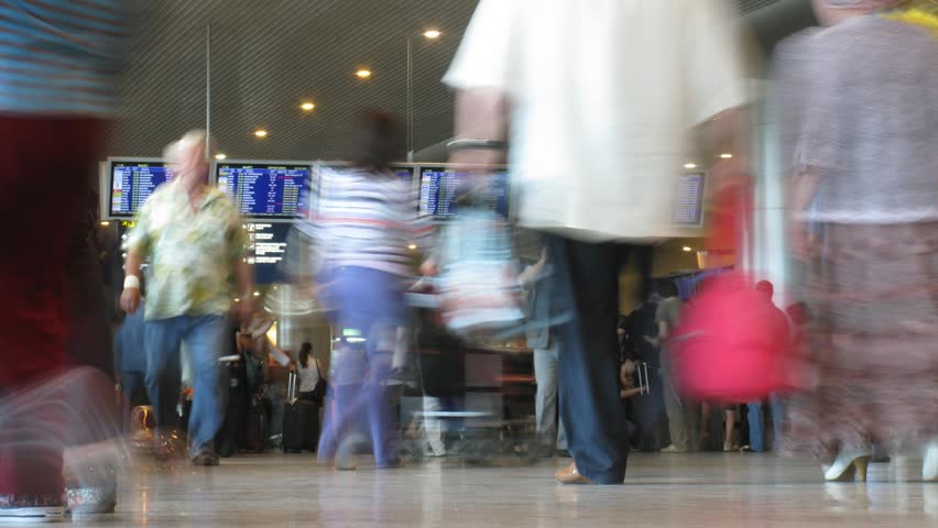 MOCSOW - JUNE 16: Passengers with luggage and board in hall of the airport Domodedovo June 16, 2009 in Moscow, Russia. Domodedovo is RussiaÃ¢â¬â¢s largest airport in terms of passenger and cargo traffic. 