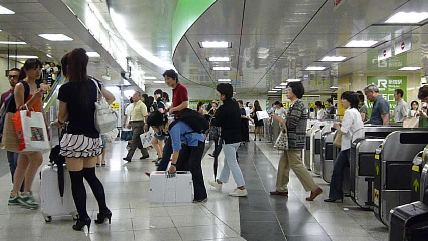 TOKYO - AUGUST 31: People passing through a ticket gate in Tokyo on August 31th, 2009. The Tokyo metro system is the most used subway system in the world in terms of annual passenger rides.