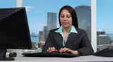 Female supervisor typing on computer - skyline background