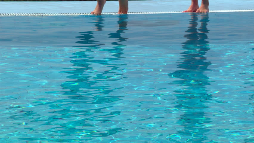 Girls jumping into the pool. PHANTOM HD Slowmotion shot