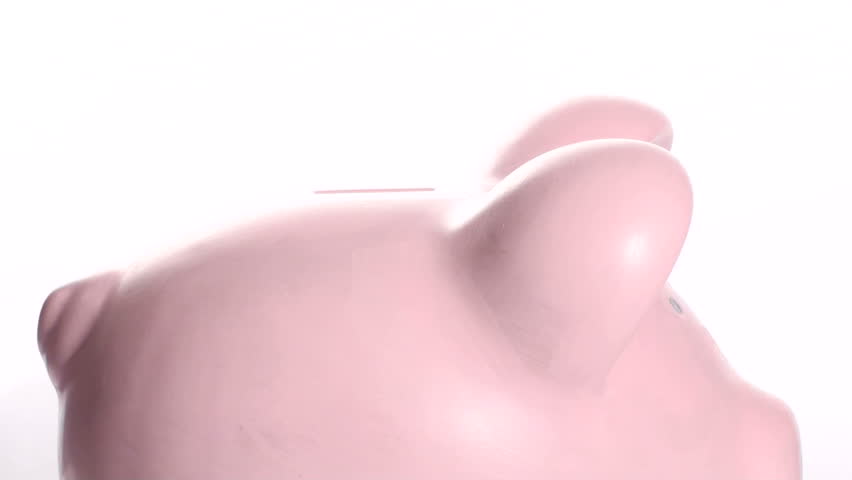 inserting coins in piggy bank - side