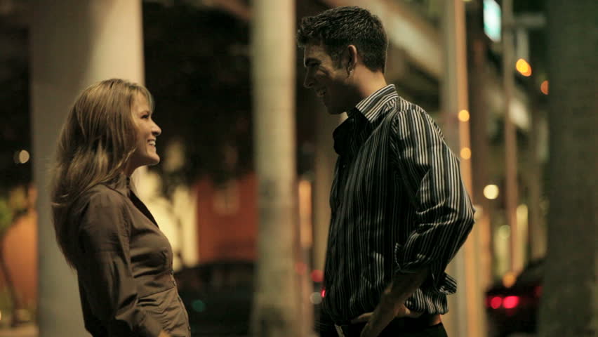 Woman flirting with a man at night